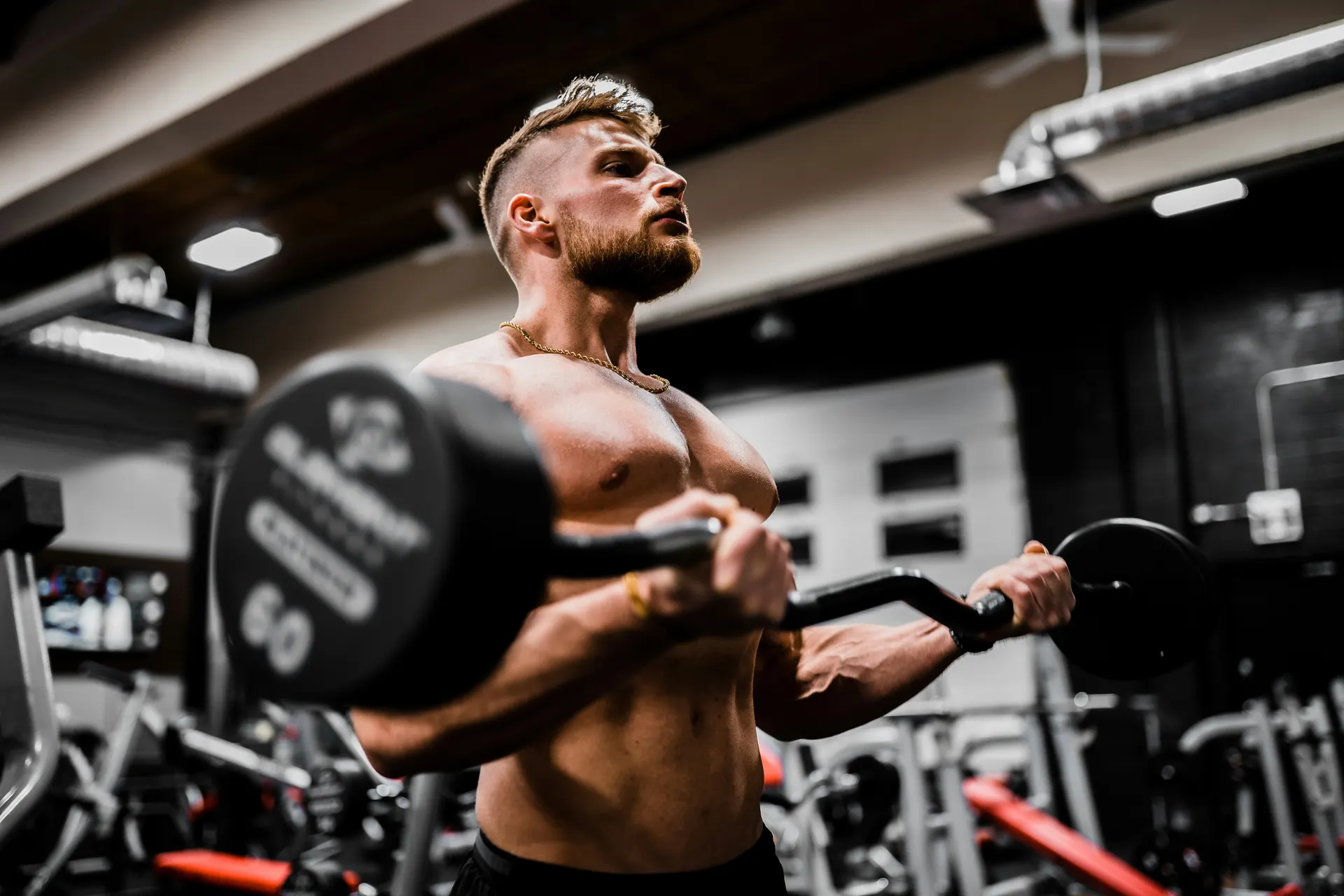 Person doing strength training with dumbbells or a bar, focused