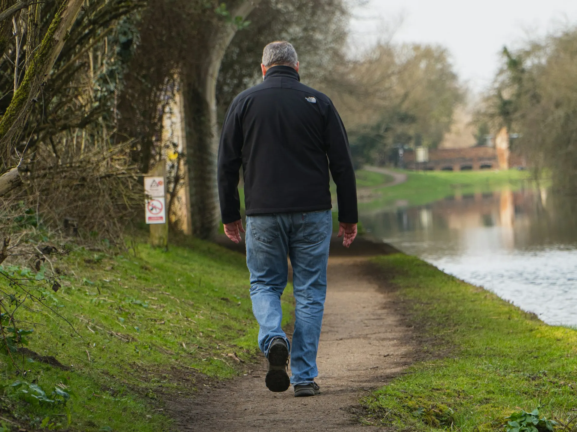 Person over 60 walking or doing a balance exercise