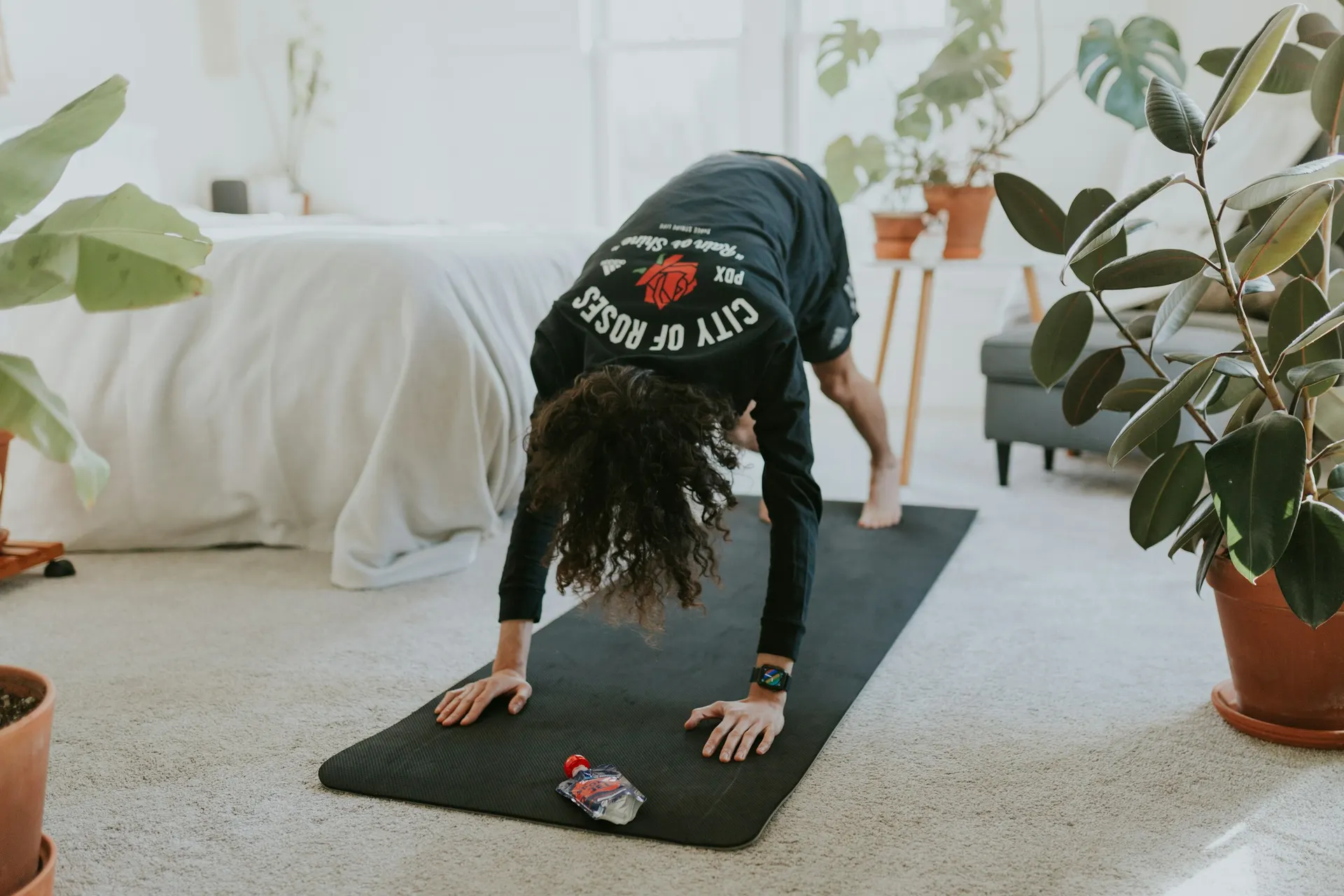 Person exercising in their living room with a mat and little equipment