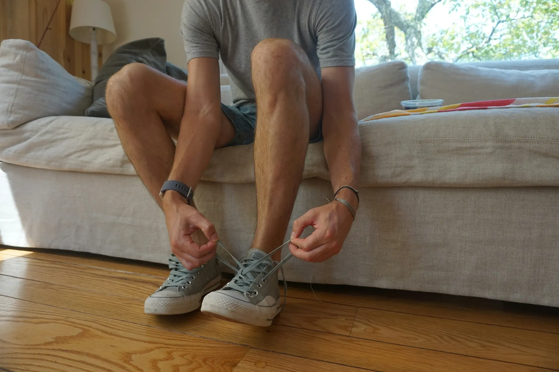 Person tying their trainers at home before going out